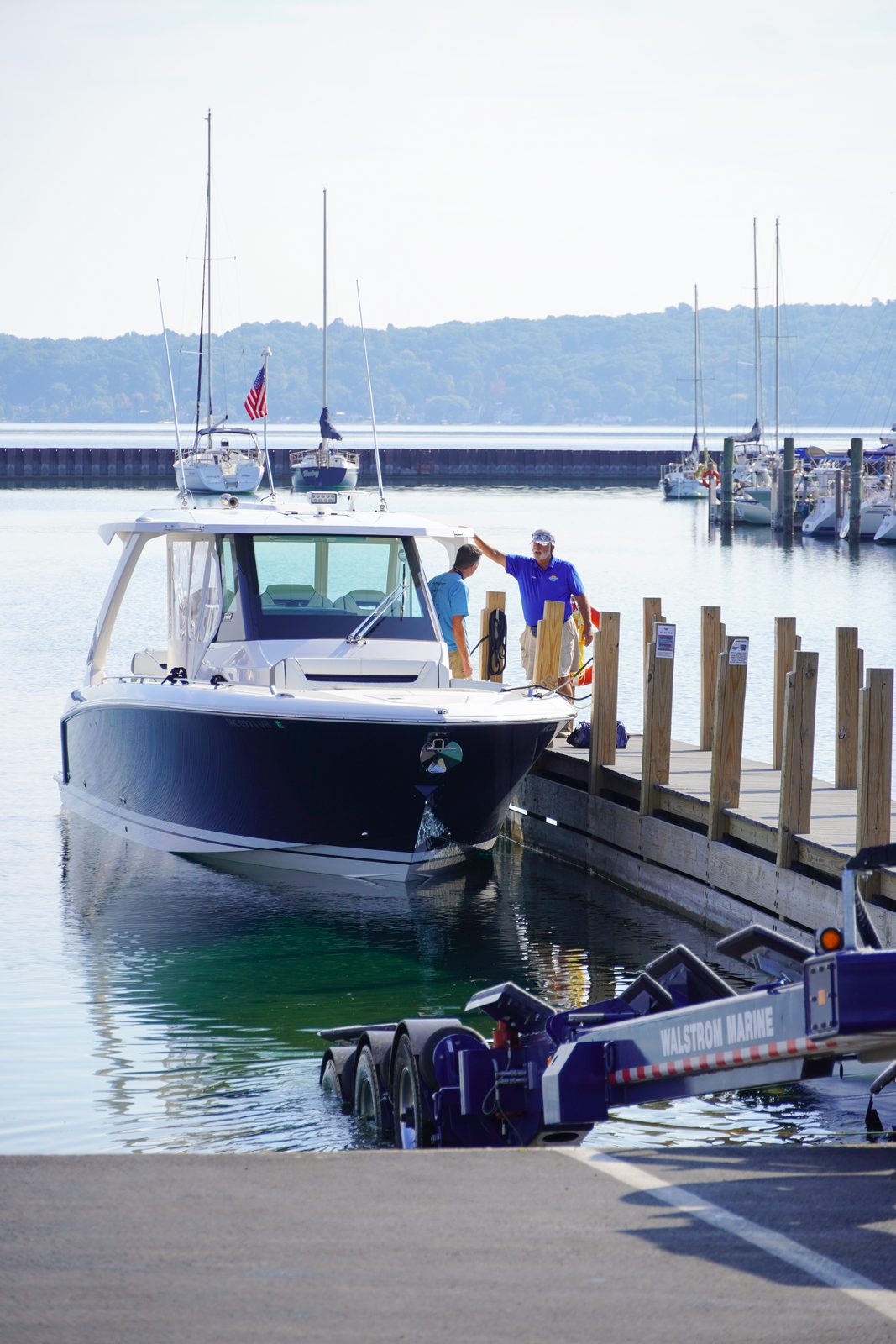 Marina staff helping bring a boat in at the launch ramp.